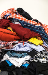 Different clothes and fabrics stacked in pile