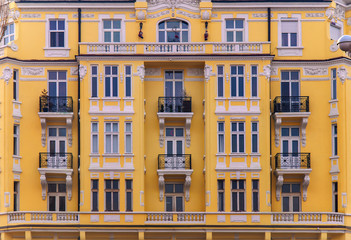 Urban yellow building with blue window
