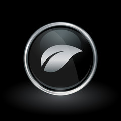 Plant symbol with leaf icon inside round chrome silver and black button emblem on black background. Vector illustration.