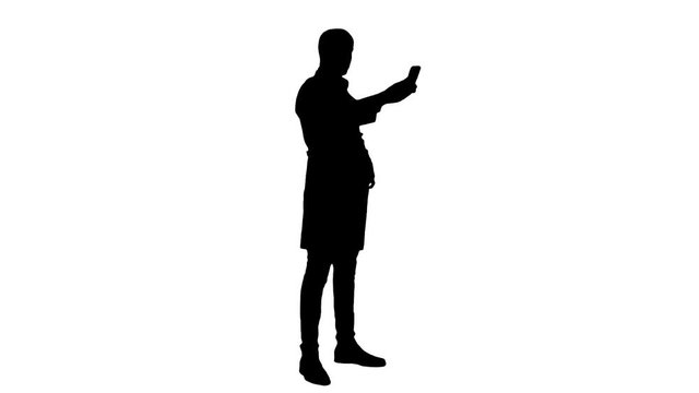 Silhouette Smiling doctor in white coat taking selfie on his phone