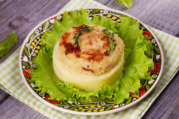 Fish patty with mashed potato and lettuce. View from above, top studio shot