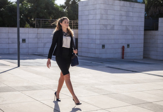 Young businesswoman walking outdoors