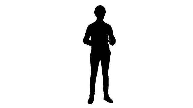 Silhouette Happy young engineer wearing helmet talking to the camera