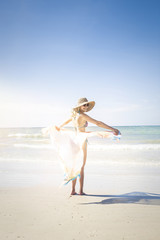Fototapeta na wymiar Beautiful woman enjoys the beach