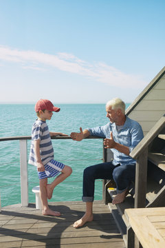 Grandfather and grandson on houseboat, Kraalbaai, South Africa