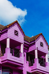 The purple house with balconies. The purple colored suburban house with small terraces. Vertical outdoors shot.