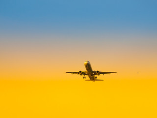 Fototapeta na wymiar Aircraft take-off from airport at sunset time. Air transportation and leaving on holiday theme.