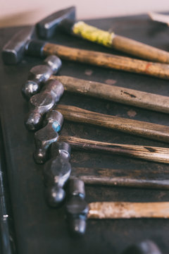 Row of hammers on forge workbench