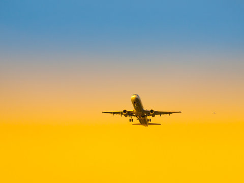 Aircraft take-off from airport at sunset time. Air transportation and leaving on holiday theme. © pyty