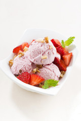 delicious strawberry ice cream in a bowl, vertical