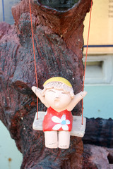 doll little girl on a swing