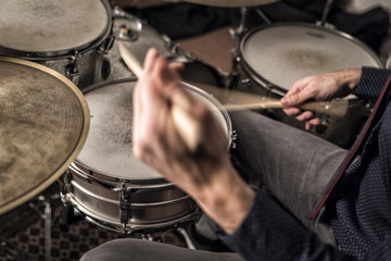 Drummer rolling on snare, closeup, back view, motion blur