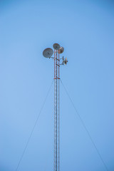 Radio tower with blue sky,silhouette antenna broadcasting network frequency transmitter communication satellite
