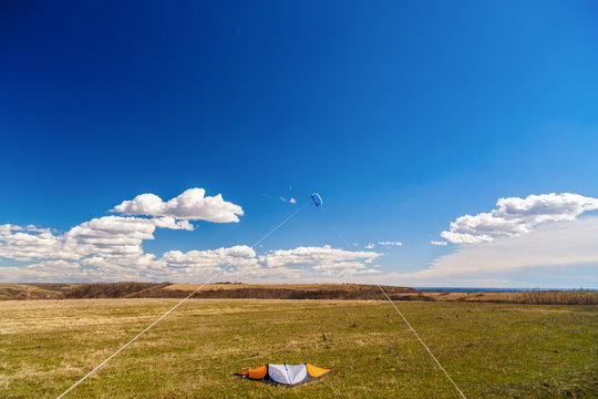 picture with a kite in the sky with clouds