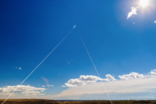 picture with a kite in the sky with clouds