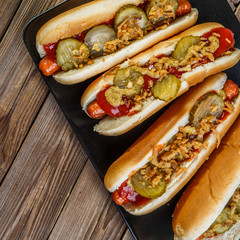 American hot dog with pickles,onions, ketchup and mustard