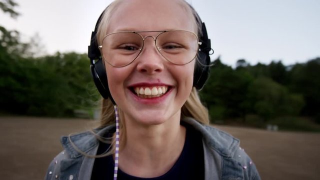 Happy and spinning around. A lifestyle portrait of modern young teenage girl wearing a worn out jeans jacket. Mixed modes happy and contemplative. Sweden, Stockholm