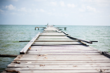 Wooden pier on the sea background