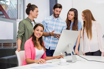 Fototapeta premium Executives discussing over digital tablet in conference room