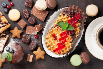 Coffee, sweets and waffles with berries