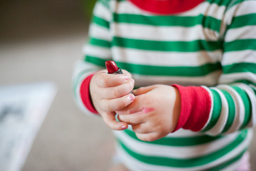 Baby girl playing with lipstick