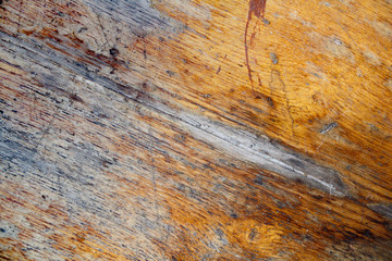 Naklejka premium Fragment of old wooden table with a damaged layer. Abstract background
