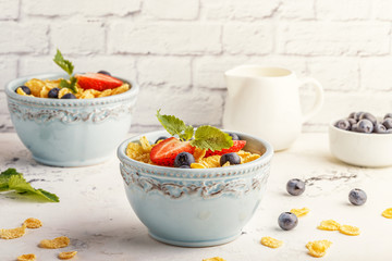 Healthy breakfast - corn flakes with fruits and berries.