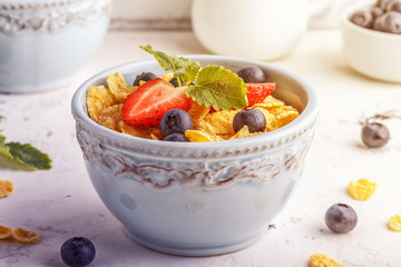 Healthy breakfast - corn flakes with fruits and berries.