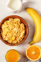 Healthy breakfast - bowl of corn flakes, nuts and fruit