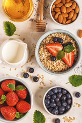 Healthy breakfast - a bowl of oatmeal, berries and fruit, top view.