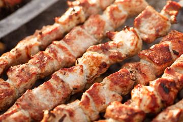 Delicious skewers of pork and lamb kebab are fried on a barbecue in nature. delicious shishkebab...