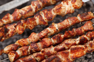 Delicious skewers of pork and lamb kebab are fried on a barbecue in nature. delicious shishkebab...