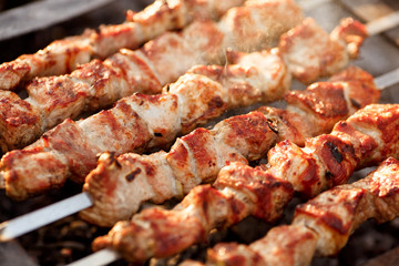 Delicious skewers of pork and lamb kebab are fried on a barbecue in nature. delicious shishkebab...