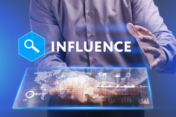 Fototapeta premium Business, Technology, Internet and network concept. Young businessman working on a virtual screen of the future and sees the inscription: Influence