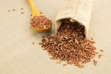 Red jasmine rice in small hemp sacks.