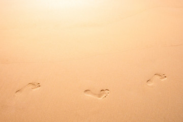 Footprints on a sandy beach.