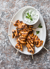 Delicious appetizer or snack - chicken skewers and tzaziki sauce. Top view