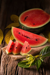 watermelon pieces on a brown wooden background