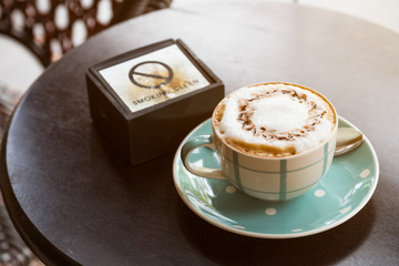 Cup of coffee and ashtray on the table.