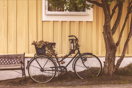 Old rusty bicycle in front of a Swedish house