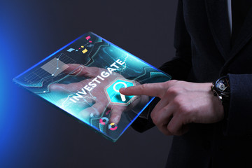 Business, Technology, Internet and network concept. Young businessman working on a virtual screen of the future and sees the inscription: Investigate
