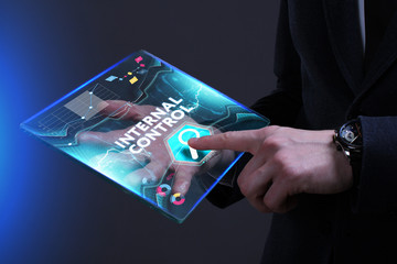 Business, Technology, Internet and network concept. Young businessman working on a virtual screen of the future and sees the inscription: Internal control
