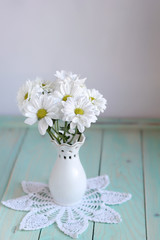 Still life with white chrysanthemums in vase on table background. floral gift. composition with flowers. template for design