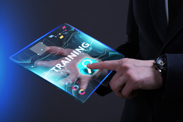 Business, Technology, Internet and network concept. Young businessman working on a virtual screen of the future and sees the inscription: Training
