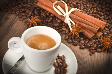 coffee cup with beans on wooden table