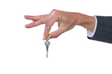 Hand of businessman holding key
