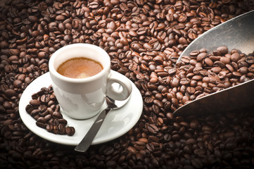 coffee cup with beans on wooden table