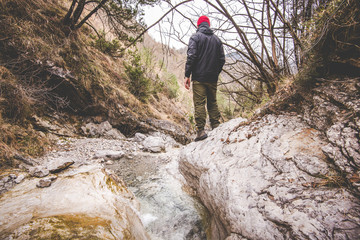 Obraz premium hiker exploring a little creek - wanderlust travel concept with sporty people at excursion in wild nature - outdoor activity Italy