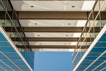 Obraz premium Urban Geometry, looking up to glass building. Modern architecture, glass and steel. . Abstract architectural design. Inspirational, artistic image.Minimal art. Architectural design. Building exterior.