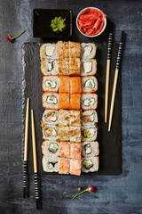 Japanese Sushi - Set of Maki Sushi Roll, Soy Sauce and Ginger over Stone Background